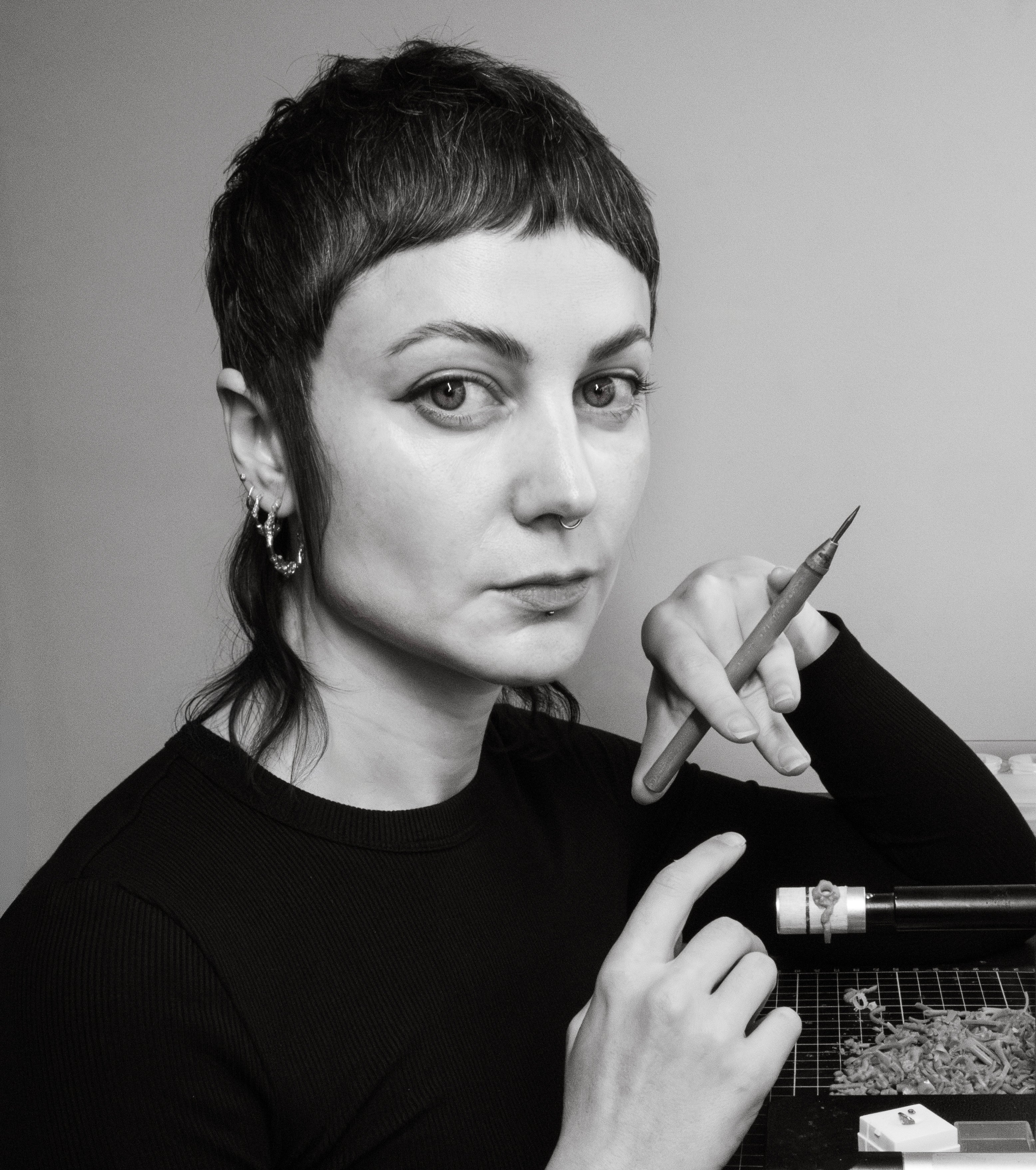 Portrait of Melbourne jeweller Alicia Hannah Naomi holding a wax carving tool.
