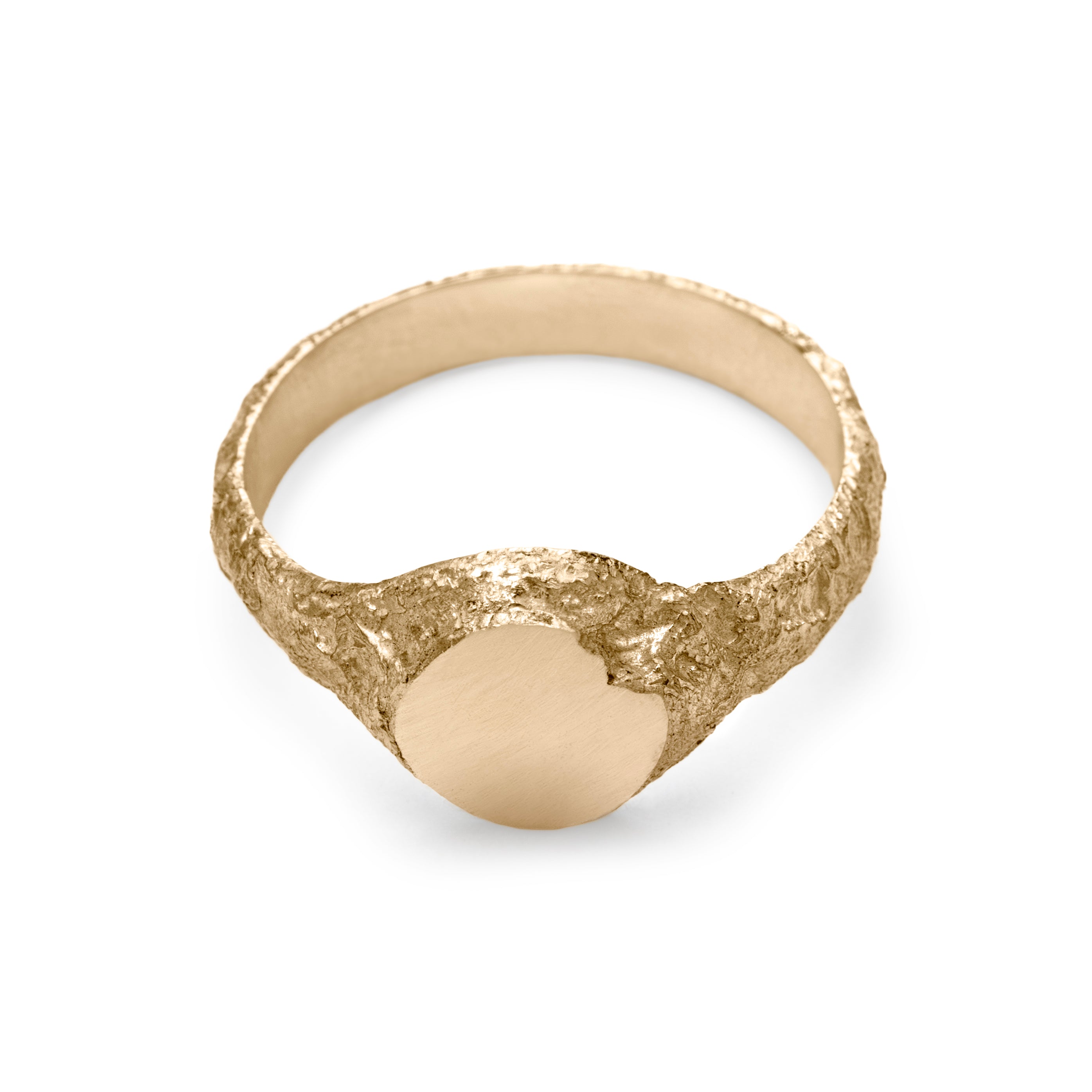 Gold signet ring showing inside view with eroded texture and matte circular face with chipped detail.