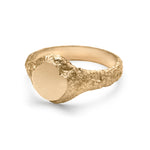 Geological texture detail view of small gold signet ring.