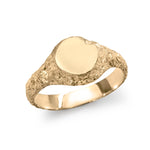 Gold signet ring showing inner polished band and exterior eroded texture.