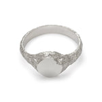 Inside view of small round signet ring in sterling silver with textured band and matte face.