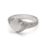 Small textured silver signet ring showing geological band detail.