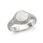Small round textured silver signet ring showing polished inner band detail.