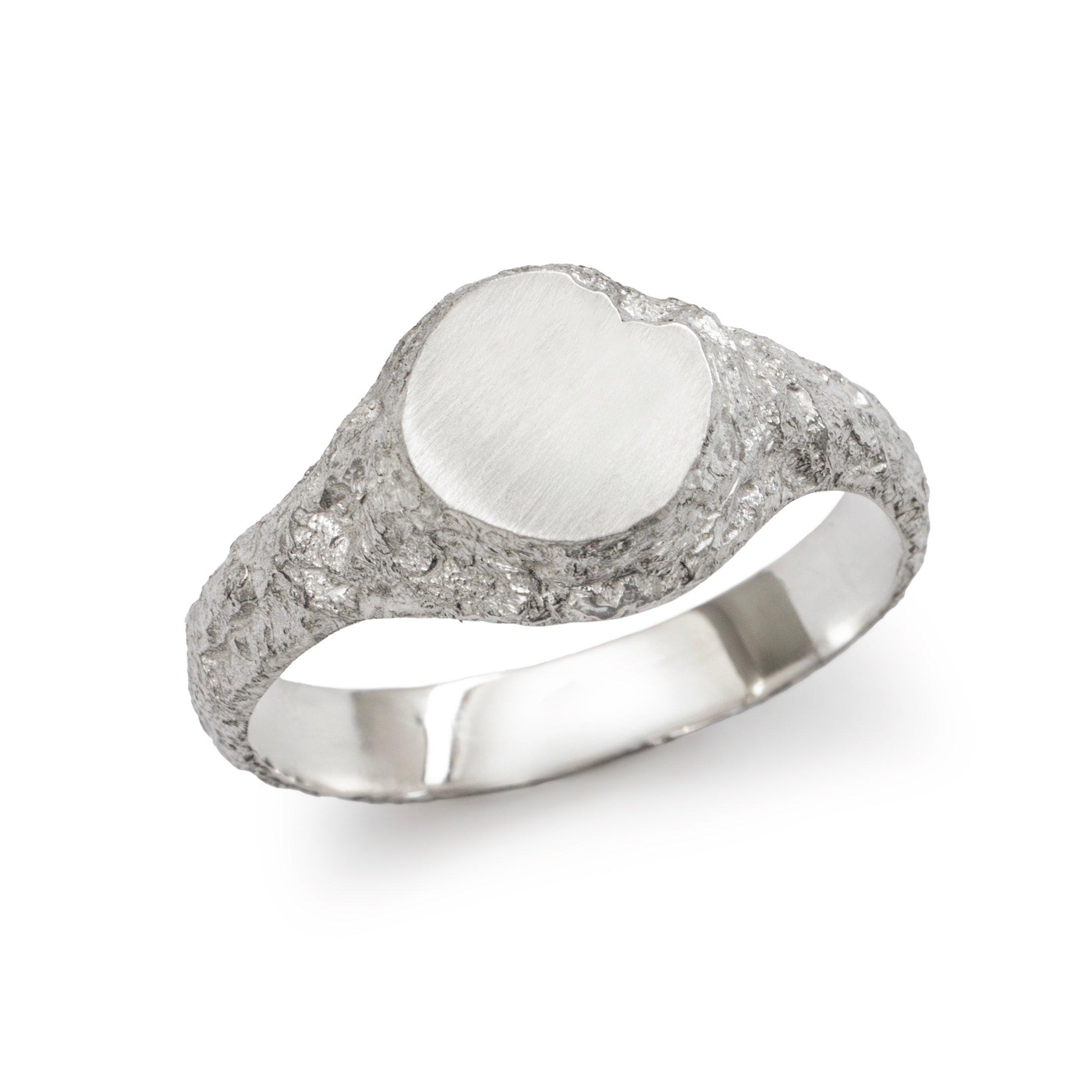Small round textured silver signet ring showing polished inner band detail.