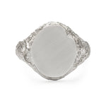 Oval signet ring in sterling silver with textured shoulders and chipped facade.
