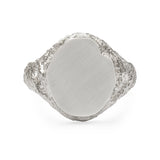 Oval signet ring in sterling silver with textured shoulders and chipped facade.