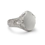 Side detail of signet ring in sterling silver with textured shoulders and chipped facade.