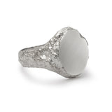 Side detail of signet ring in sterling silver with textured shoulders and chipped facade.