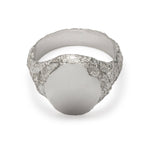 Top view of signet ring in sterling silver with textured shoulders and chipped facade.
