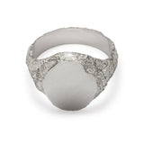 Top view of signet ring in sterling silver with textured shoulders and chipped facade.