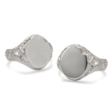Two oval signet rings side by side with textured detail, the left ring has a matte face and the right has a polished face.