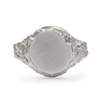 Medium round signet ring in sterling silver with chipped detail of face and textured band.
