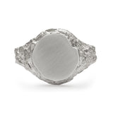 Medium round signet ring in sterling silver with chipped detail of face and textured band.
