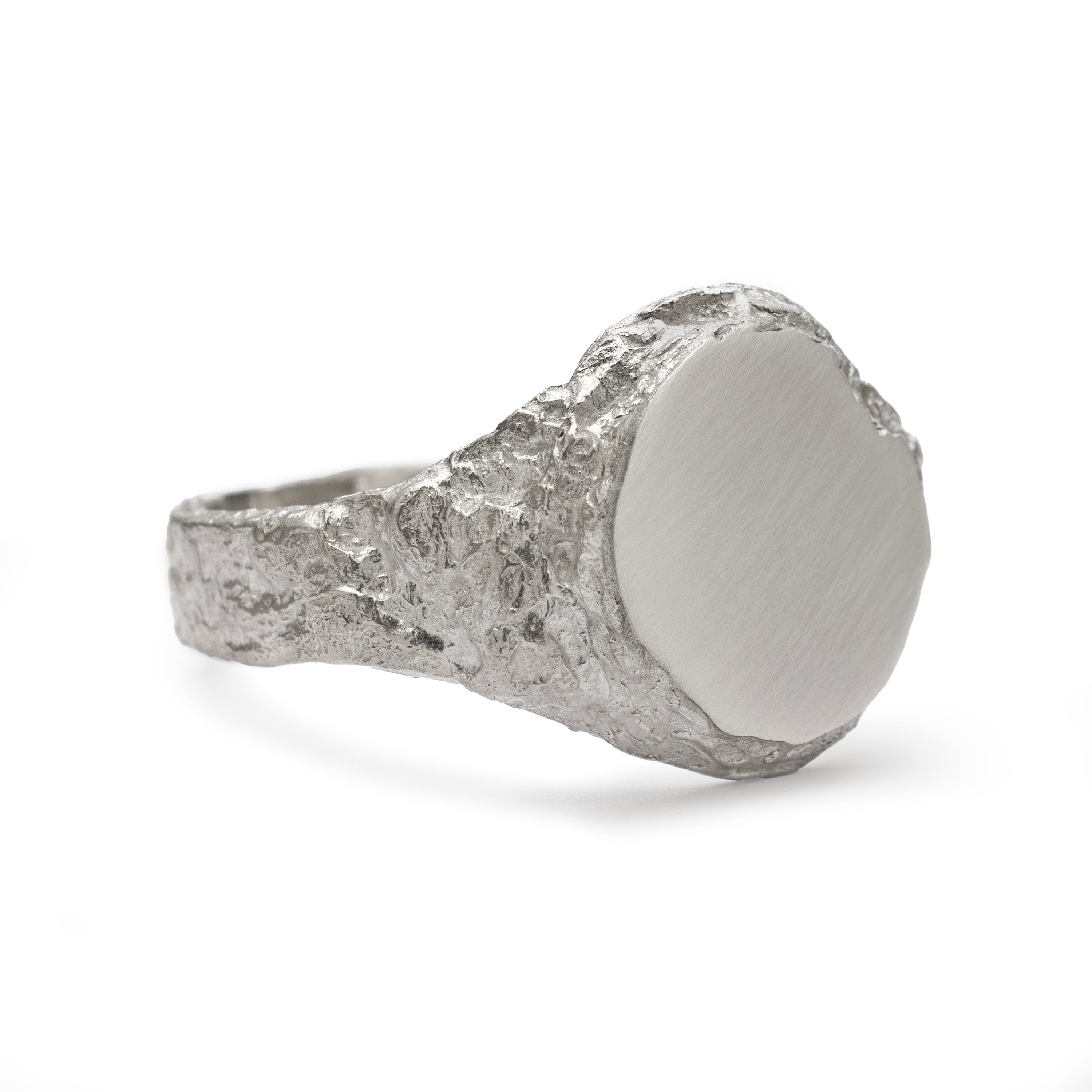 Geological view of side signet ring in sterling silver with matte face and textured band.