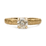 Champagne diamond engagement ring with textured gold band and four-claw setting.