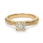 Champagne diamond engagement ring with slim textured gold band and four-claw setting.
