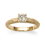 Champagne diamond engagement ring detail photo with textured gold band and four-claw setting.