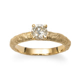 Champagne diamond engagement ring detail photo with textured gold band and four-claw setting.