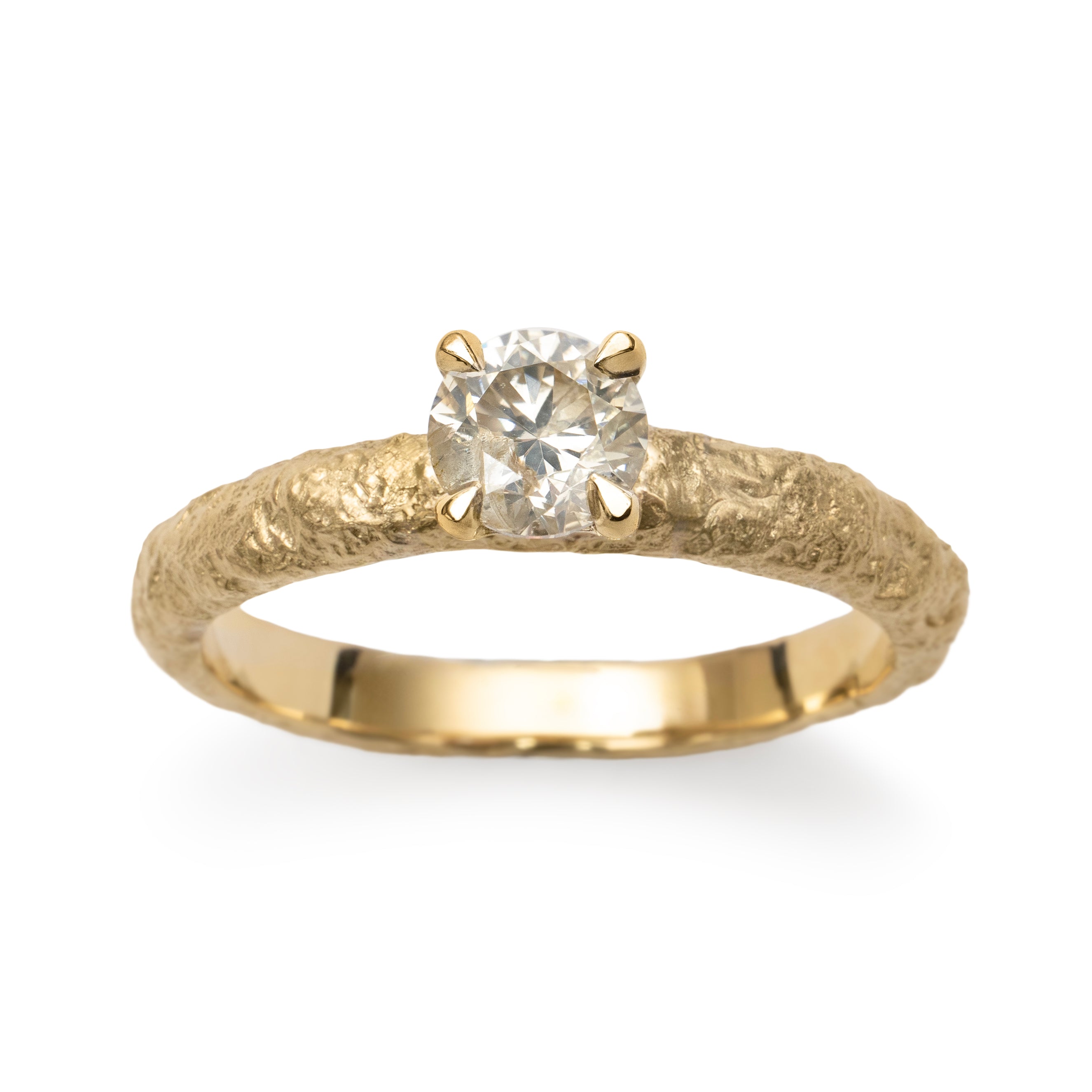 Champagne diamond engagement ring detail photo with textured gold band and four-claw setting.