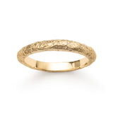 Textured yellow gold wedding band with eroded surface.