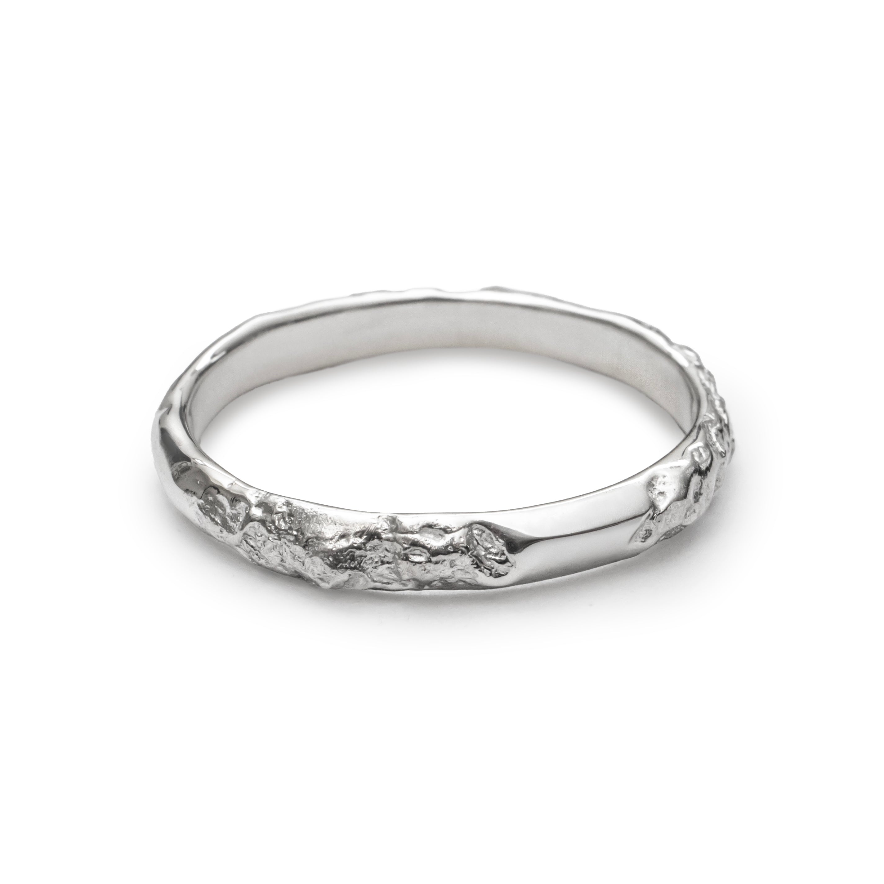Silver ring with a textured design on a white background